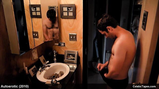Hot shirtless Latino celeb flexing muscles in bathroom mirror