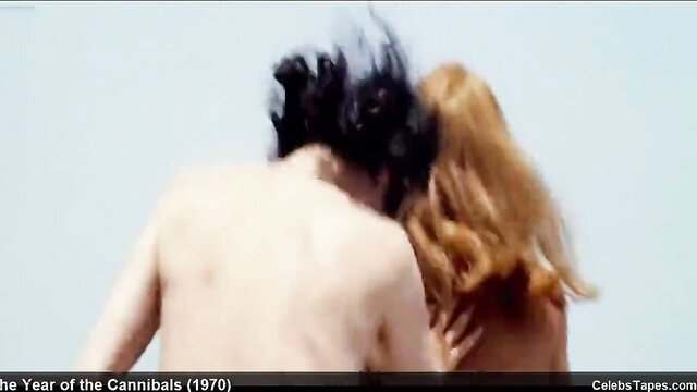 Britt Ekland nude couple embrace beach scene Cannibals 1970