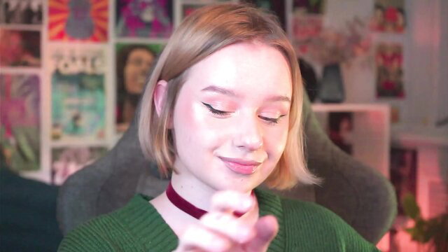 AdeleLoomis blonde webcam girl smiling in green sweater closeup