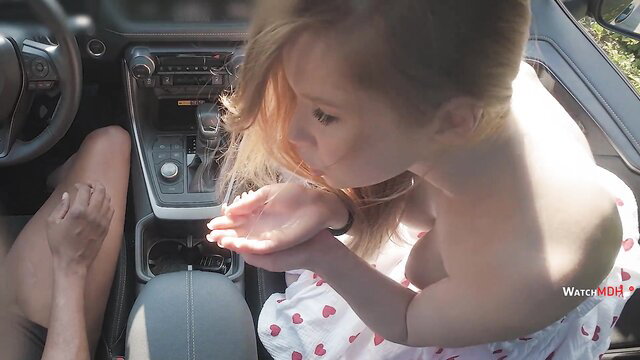 Blonde girl blowing cum from hands in car with woman