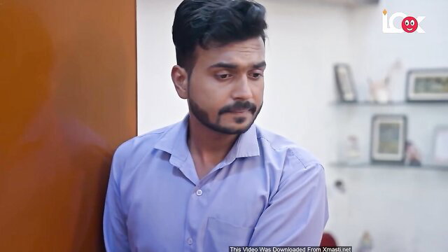 Handsome Indian man in light blue shirt, intense gaze in adult web series