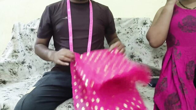 Mumbai Ashu in pink dress with Indian tailor holding fabric