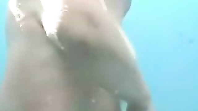 Mature busty wife wet nude underwater in beach shower cabin