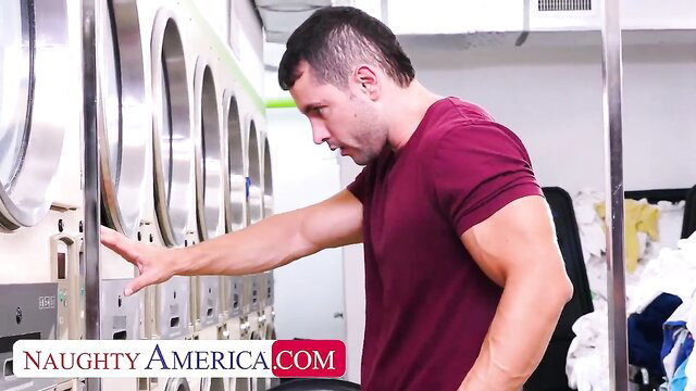 Muscular man at laundromat in Naughty America video with Keely Rose