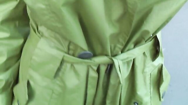 Cute Russian brunette teen in shiny green raincoat flashing big natural tits