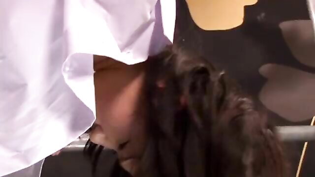 Asian woman in white shirt bent over for QC inspection at Kittycat House