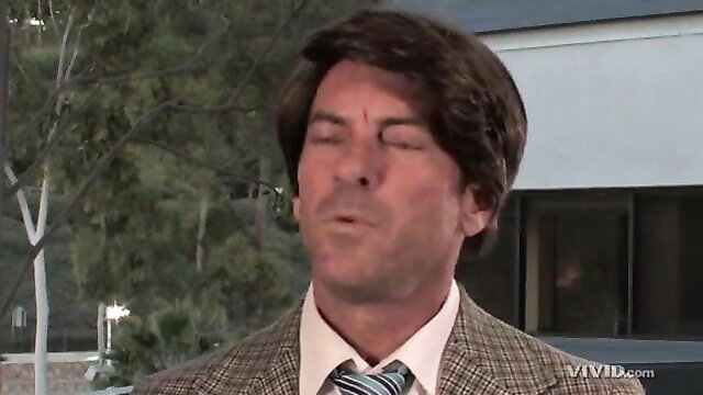 Lily Labeau as sexy brunette in suit licks lips in Hulk XXX parody