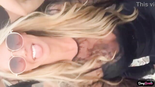 Blonde bombshell Deny Barbie smiles seductively in sunglasses at wild party