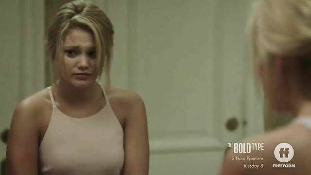 Blonde woman in beige slip dress crying emotional closeup