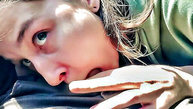 Teen girl with green eyes sucking finger closeup in public bus