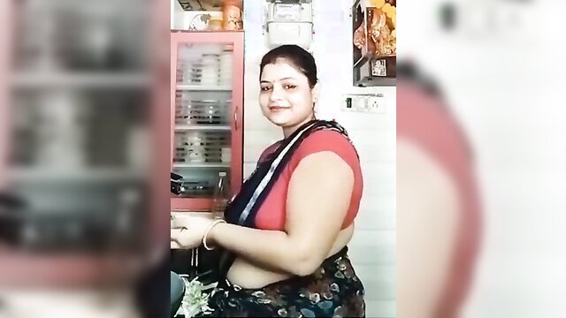 Curvy Indian MILF in red saree blouse showing big ass and belly