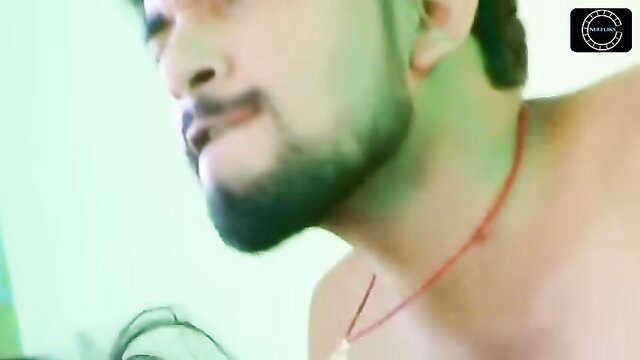 Handsome Indian man with beard and necklace in hot closeup