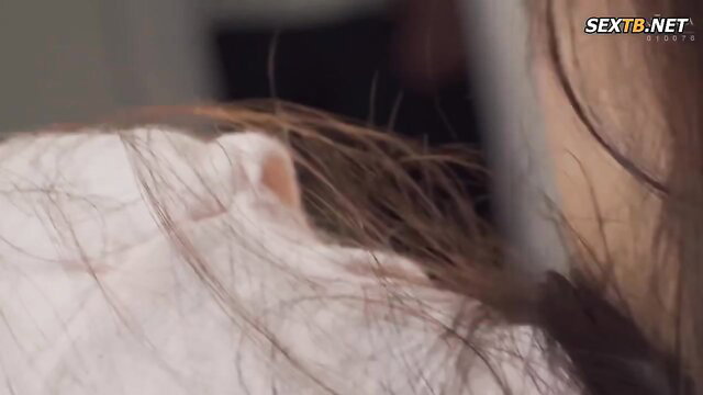 Closeup of Japanese woman's ear and long blonde hair in JAV scene
