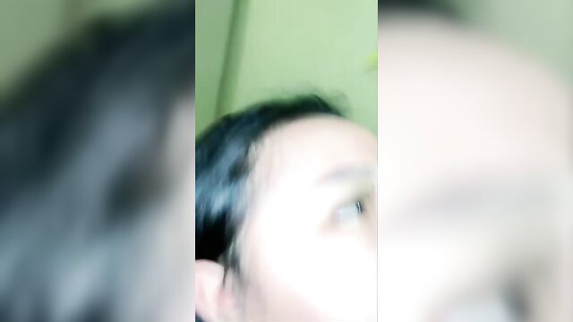 Blurry closeup of Indonesian amateur woman's face watching porn