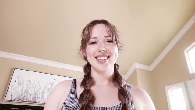 Ashley Red smiling in tank top with pigtails, hot friend vibe