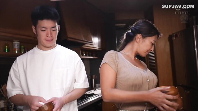Asian couple in kitchen foreplay during wife's pregnancy