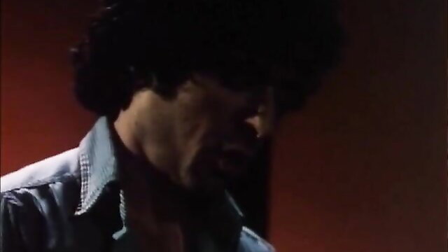 Closeup of 1980s curly-haired hunk in open shirt from San Fernando Valley Girls