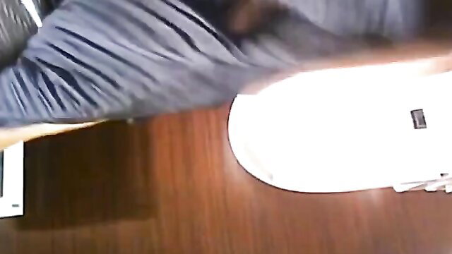 Japanese woman squatting over toilet in gray shirt, white sneakers, upskirt voyeur