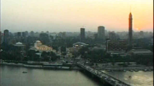 Vintage 1996 Pyramid 2 aerial view of Cairo skyline at sunset over Nile