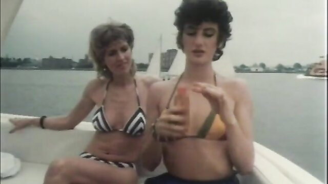 Two busty 80s babes in bikinis on boat in Hot Dreams 1983 vintage porn