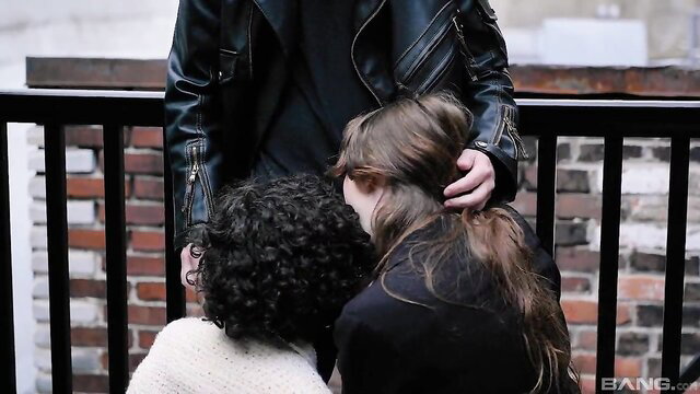 18yo brunette hugged from behind on balcony by leather-clad guy