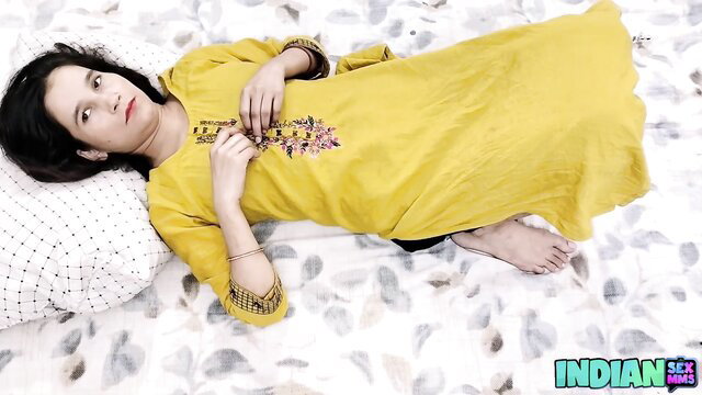 Hot Indian wife in yellow salwar kameez lying seductively on bed