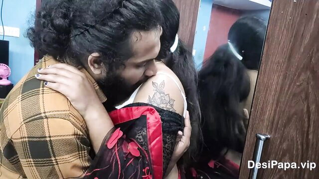 Indian couple embraces intimately, tattoos visible on her shoulder