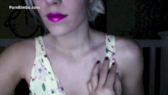 Divine Goddess Jessica in yellow floral dress, purple lips, hypnotic hand gesture