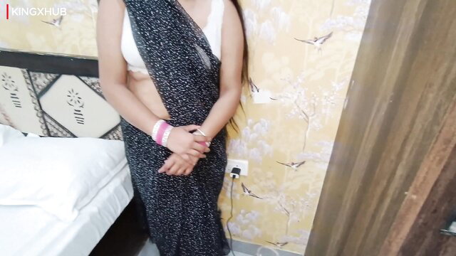 Hot Indian bhabhi in sheer black saree and white blouse exposing midriff
