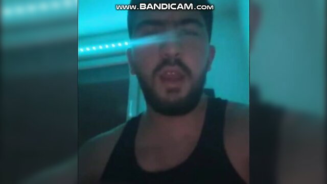 Handsome Middle Eastern man with beard in tank top, blue neon glow amateur thumbnail