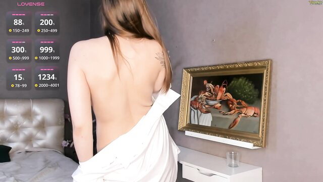 Busty Asian cam girl topless back view in white sheet tease