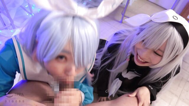 Two cosplay girls in maid bunny outfits kissing intimately close-up