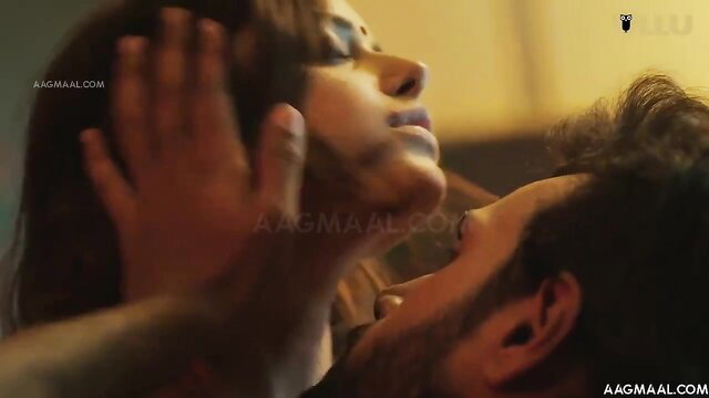 Indian beauty with thick lips in intense closeup kiss, hands gripping face passionately