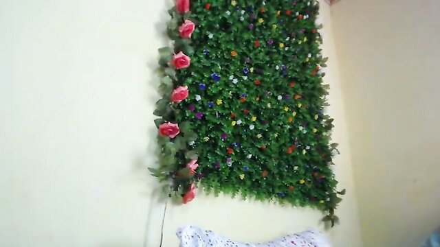 lingerie model posing near floral wall decoration