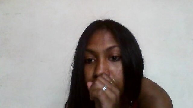 Closeup of stunning Black woman with long black hair, hand over mouth, seductive gaze