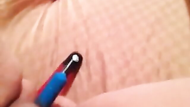 Closeup of lonely mature blonde applying lipstick nude