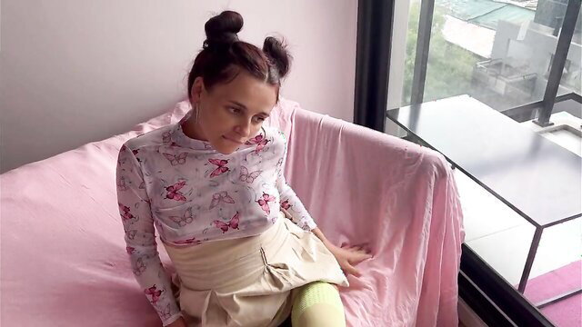 Cute pregnant schoolgirl in pigtails and uniform skirt poses seductively