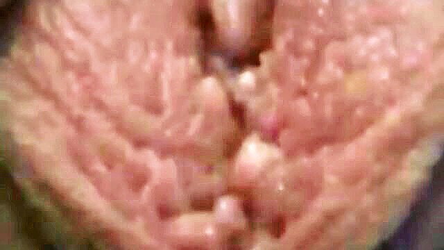 Closeup of wet pink pussy lips spread with creamy white cum dripping out