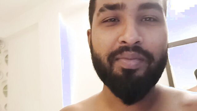Handsome bearded Indian man shirtless in bathroom after marriage