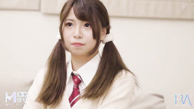 Modest cutie Asian schoolgirl in uniform with pigtails closeup