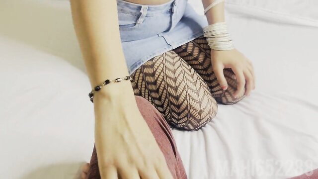 Indian student in fishnet stockings and denim skirt sitting on bed, hot amateur pose