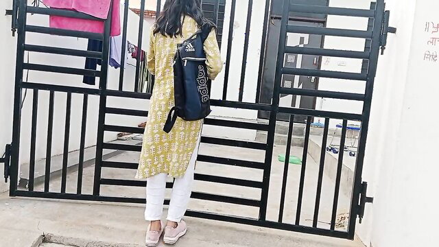 Indian college girl in yellow kurti white pants at gate with Adidas backpack
