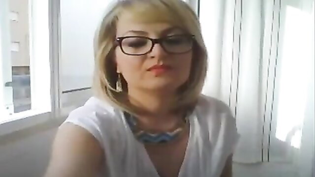 Cute short haired mature blonde in glasses on webcam