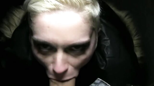 Short-haired pale floozie in leather jacket stares intensely close-up