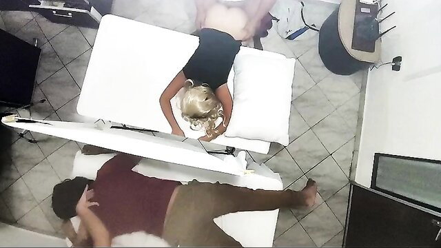 Blonde masseuse straddles client on table in erotic massage sex