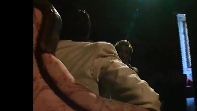 Blonde woman in white dress fucked from behind by man on chair