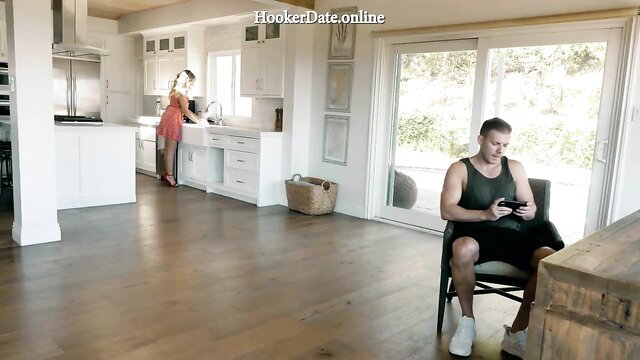 Cory Chase in red mini dress bends over kitchen counter teasing