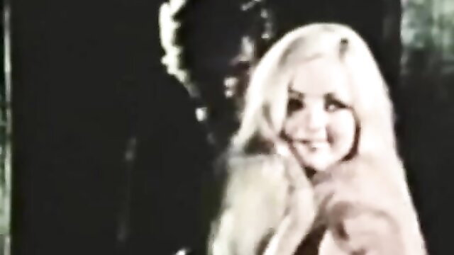 Vintage blonde bombshell smiling with man in classic Tabu Film porn