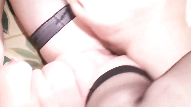 Closeup of woman fingering pussy in black stockings and garter belt