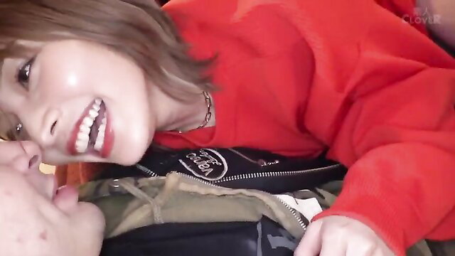 Asian beauty with short brown hair smiles intimately in red hoodie POV tease